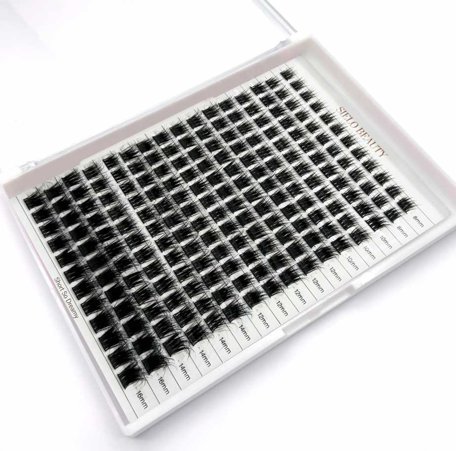 Product photograph by SIELO BEAUTY showing a white tray filled with organized black pre-made volume eyelash extension fans, categorized by lengths from 8mm to 16mm, with Short So Dreamy printed on the side